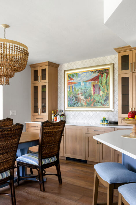 0S3A0640_jpg Dining nook with woven chairs and bar area with glass-front cabinets and colorful artwork