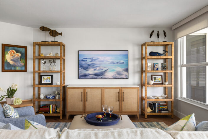 0S3A0670_ Living room with rattan étagères flanking a cane-front console and ocean artwork
