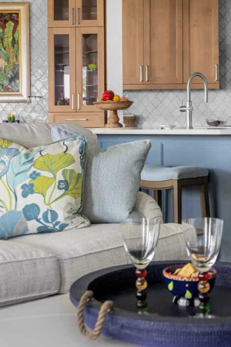 0S3A0759-Edit Sofa with tropical print pillows and serving tray with wine glasses