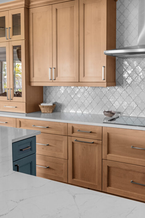 0S3A0784 Kitchen with wood cabinetry, glass-front uppers and white scallop tile backsplash