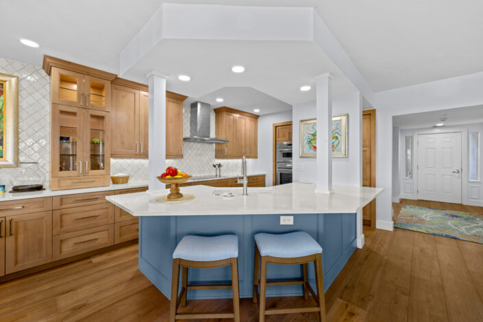 lands-end-penthouse-0S3A0343 Kitchen with blue island, white quartz countertops and natural wood cabinetry